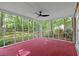Bright sunroom with a red-painted floor, screened windows, and backyard views provides a relaxing space at 103 Sylvan Ter, Summerville, SC 29485