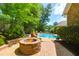 Backyard fire pit and pool area with comfortable seating, surrounded by lush greenery at 1069 Blockade Runner Pkwy, Summerville, SC 29485