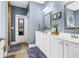 A primary bath has dual vanities, framed mirrors, and tile floors at 1069 Blockade Runner Pkwy, Summerville, SC 29485