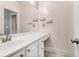 Bathroom features white vanity with a large mirror and brass fixtures at 1069 Blockade Runner Pkwy, Summerville, SC 29485