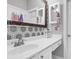 Bathroom with a white vanity with decorative mirror and geometric backsplash at 1069 Blockade Runner Pkwy, Summerville, SC 29485