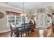An open dining room offers a large table, hardwood floors, and a view to a pool at 1069 Blockade Runner Pkwy, Summerville, SC 29485