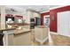 An open concept kitchen offers granite countertops, a center island, and black appliances at 1069 Blockade Runner Pkwy, Summerville, SC 29485