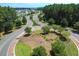 Aerial view of roundabout featuring manicured landscaping, mature trees, and winding streets lined with homes at 107 Pescaro Ln, Summerville, SC 29486