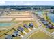 Comprehensive aerial view showcasing neighborhood with scenic ponds, planned developments, and harmoniously arranged homes at 107 Pescaro Ln, Summerville, SC 29486