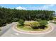 Aerial view of well maintained roundabout featuring landscaping, mature trees and winding streets at 107 Pescaro Ln, Summerville, SC 29486