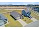 New construction home with two-car garage and manicured lawn in a Gathering-friendly neighborhood at 107 Pescaro Ln, Summerville, SC 29486