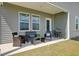 Relaxing back porch features comfortable wicker seating and a view of the lush backyard at 107 Pescaro Ln, Summerville, SC 29486