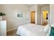 Bright bedroom with a white bed and soft neutral tones showcases a view to the ensuite at 107 Pescaro Ln, Summerville, SC 29486