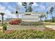 Woodwinds community entrance featuring a decorative sign with flowers and manicured bushes at 107 Pescaro Ln, Summerville, SC 29486
