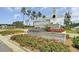 Landscaped entrance sign for Woodwind community with colorful flower beds and manicured shrubs at 107 Pescaro Ln, Summerville, SC 29486