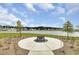 Outdoor fire pit and seating area with view of lake and homes in the Cane Bay Plantation community at 107 Pescaro Ln, Summerville, SC 29486