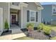 Home's entry shows dark front door with decorative wreath and manicured landscaping at 107 Pescaro Ln, Summerville, SC 29486