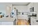 Bright kitchen features stainless steel appliances, granite countertops, an island with bar seating, and ample cabinet space at 107 Pescaro Ln, Summerville, SC 29486