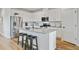 Kitchen boasts stainless steel appliances, white cabinets, granite countertops, and a central island with bar seating at 107 Pescaro Ln, Summerville, SC 29486