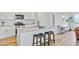 Well-lit kitchen with an island features bar seating, stainless steel appliances, and modern fixtures at 107 Pescaro Ln, Summerville, SC 29486
