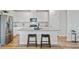 Kitchen island features bar seating, stainless steel appliances, white cabinets and stone countertops at 107 Pescaro Ln, Summerville, SC 29486