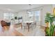 Open-concept living and dining area with plenty of natural light, modern decor, and wood flooring at 107 Pescaro Ln, Summerville, SC 29486