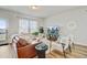 Cozy living room featuring a leather sofa, comfortable seating, and lots of natural light from the windows at 107 Pescaro Ln, Summerville, SC 29486