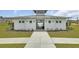 Modern pool house exterior features white siding, a metal roof, and a concrete walkway at 107 Pescaro Ln, Summerville, SC 29486