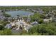Picturesque aerial view of a residential area featuring a scenic lake and houses surrounded by lush greenery at 1087 Clearspring Dr, Charleston, SC 29412