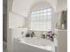 Inviting tub with tiled surround and large frosted window offers a tranquil escape at 1087 Clearspring Dr, Charleston, SC 29412