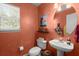 Cozy powder room with round mirror, toilet, and pedestal sink at 1087 Clearspring Dr, Charleston, SC 29412