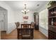 Traditional dining room with wood table, chairs, chandelier and bright window at 1087 Clearspring Dr, Charleston, SC 29412