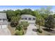 Traditional two-story home with neutral siding, black shutters, palm trees, and a well-manicured lawn at 1087 Clearspring Dr, Charleston, SC 29412