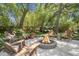Relaxing outdoor fire pit with Adirondack chairs and tropical foliage, ideal for gatherings at 1087 Clearspring Dr, Charleston, SC 29412