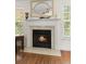Inviting fireplace with mantel and hearth, framed by windows offering natural light at 1087 Clearspring Dr, Charleston, SC 29412