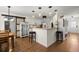 Bright, white kitchen with hardwood floors, stylish pendant lights, and modern appliances at 1087 Clearspring Dr, Charleston, SC 29412