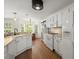 Bright kitchen with white cabinets, hardwood floors, modern appliances, and a breakfast nook at 1087 Clearspring Dr, Charleston, SC 29412