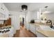 Bright, white kitchen with updated appliances, hardwood floors, and a view into the dining room at 1087 Clearspring Dr, Charleston, SC 29412