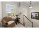 Landing with wicker chair, natural light, and decorative plants at 1087 Clearspring Dr, Charleston, SC 29412
