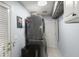 Convenient laundry room with stacked washer and dryer, storage, and access door at 1087 Clearspring Dr, Charleston, SC 29412