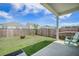 Lush backyard with a fenced perimeter, covered patio, and plenty of room to play at 110 Green Passage Ln, Summerville, SC 29486