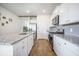 Bright kitchen with stainless steel appliances, granite counters, island with seating and wood plank flooring at 110 Green Passage Ln, Summerville, SC 29486