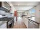 Modern kitchen features granite countertops, stainless steel appliances, and an open layout into the living area at 110 Green Passage Ln, Summerville, SC 29486