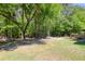 The spacious backyard is surrounded by lush trees at 110 Mapperton Ct, Summerville, SC 29485