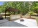 A backyard featuring a wooden pergola and a fire pit on a concrete slab at 110 Mapperton Ct, Summerville, SC 29485