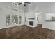 Bright living room with large windows, fireplace, and hardwood floors, creating a cozy space at 110 Mapperton Ct, Summerville, SC 29485