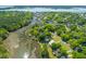 Stunning aerial view showcases waterfront property with lush landscaping and scenic surroundings at 112 Berkshire Dr, Wando, SC 29492