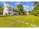 Large, grassy backyard with stone pavers connecting the home to the waterfront at 112 Berkshire Dr, Wando, SC 29492
