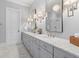 This bathroom features a double vanity with marble countertops, sleek fixtures, and a glass-enclosed shower at 112 Berkshire Dr, Wando, SC 29492