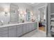 This bathroom features a double vanity with marble countertops, sleek fixtures, and modern lighting at 112 Berkshire Dr, Wando, SC 29492