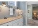 A brightly lit bathroom features a granite countertop and a view into the next room at 112 Berkshire Dr, Wando, SC 29492