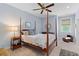 Charming bedroom with a four-poster bed, ceiling fan, and natural light, creating a cozy retreat at 112 Berkshire Dr, Wando, SC 29492
