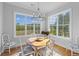 Sun-filled dining area features a wooden table and large windows with scenic views at 112 Berkshire Dr, Wando, SC 29492