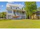 Charming waterfront home with spacious porch, lovely yard, and convenient kayak storage at 112 Berkshire Dr, Wando, SC 29492